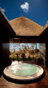 a swimming pool in a pavilion with a roof at Mokuti Etosha in Namutoni