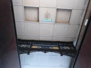 a mirror in a bathroom with a tiled ceiling at Hotel Peking in Taiping