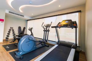 a gym with two tread machines and a treadmill at GLOW Sukhumvit 5 in Bangkok