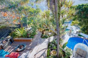 an overhead view of a garden with palm trees and a swimming pool at Villa Sol in Wilderness