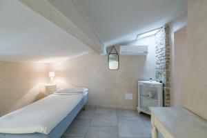 a room with a bed and a table in it at Historical stone house, in the amazing centre of Florence! in Florence