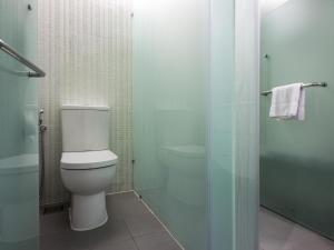 a bathroom with a toilet and a glass shower at Silka Cheras Kuala Lumpur in Kuala Lumpur