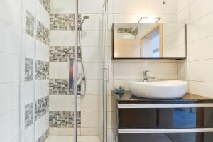 a bathroom with a sink and a shower at Crowonder Luxury Vir- 6 New Apartments for Families with Playground for Kids in Vir +74 photos