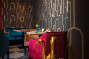 a restaurant with a pink chair and a table at Hotel Cristal Park in Dąbrowa Tarnowska