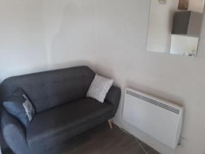 a living room with a couch and a radiator at Pigeonnier Brens in Brens