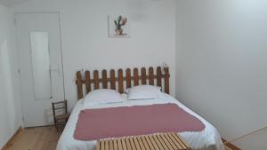 a bedroom with a large bed with a wooden headboard at Pigeonnier Brens in Brens