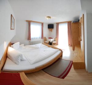 a bedroom with a large bed in a room at Wastingerhof in Obertilliach