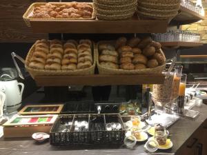 a counter with baskets of donuts and other food at Braugasthof Schmidt`s Rabenbräu in Neustift an der Lafnitz