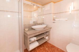 a bathroom with a sink and a toilet and a shower at Appartements Stoffenhof in Alpbach