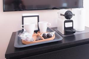 a tray with cups and a coffee maker on a counter at Bet Apartments - Canovas rooms in Valencia