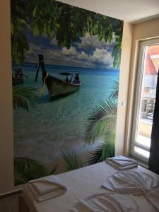 ポモリエにあるGolden Sea View Apartmentsの水上ボートの絵画が描かれたベッドルーム
