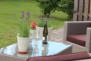 a bottle of wine and a glass on a table at Villa M in Simrishamn