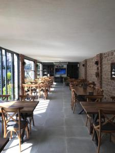 a dining room with wooden tables and chairs at Ziyabey Konagi in Ayvalık