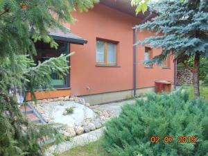 a house with a garden in front of it at Dom nad Narwią - cisza spokój rzeka jezioro in Rogóźno