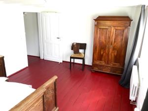 a room with a wooden floor and a wooden cabinet at Freistaat Eifel in Nettersheim