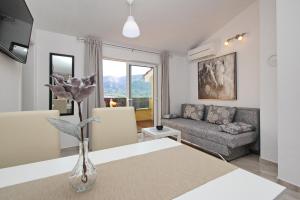 a living room with a couch and a table at Sunshine Residence Baska in Baška