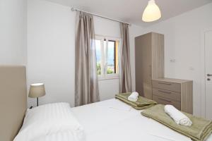 Säng eller sängar i ett rum på Sunshine Residence Baska