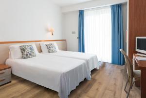 Postel nebo postele na pokoji v ubytování Hotel Bauer & Sporting