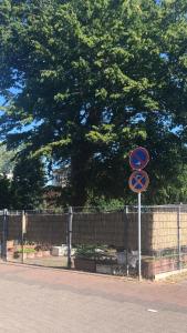 a sign on the side of a road next to a fence at 2 Privatzimmer , Dusche /WC nahe Köln in Frechen