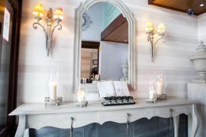 a dressing table with candles and a mirror at Palacio San Bartolomé in El Puerto de Santa María