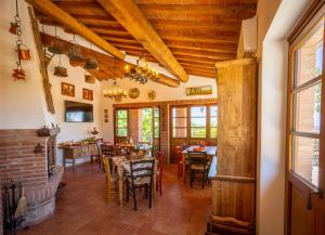 a dining room with wooden ceilings and tables and chairs at Villa Amadeo by PosarelliVillas in Montaione