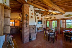 a kitchen and dining room with tables and chairs at Villa Amadeo by PosarelliVillas in Montaione