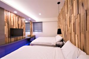 Rúm í herbergi á 晴空桂冠 Clear Sky Laurel Hotel