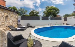 a patio with a pool and chairs next to a building at Molnar Resort Villa Mimoza & Apartment Nea in Brzac