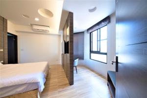 Rúm í herbergi á 晴空桂冠 Clear Sky Laurel Hotel