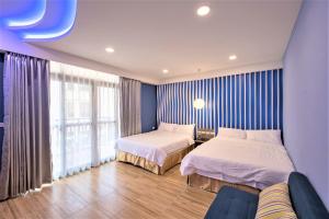 Postel nebo postele na pokoji v ubytování 晴空桂冠 Clear Sky Laurel Hotel