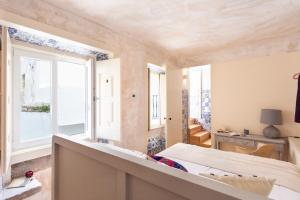 a bedroom with a bed and a window at Archi-Pelago Alfama Design Suites Guesthouse in Lisbon