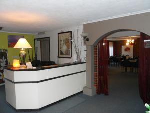 a hotel lobby with a reception counter and a dining room at Zero Inn Motel in Nhill