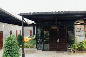 a building with doors and a sign that reads the snuggle at The Simple Koh Yao Noi in Ko Yao Noi