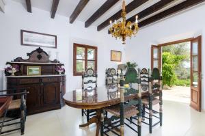 a dining room with a table and chairs and a chandelier at Puig De Garrafa 6 in Andratx