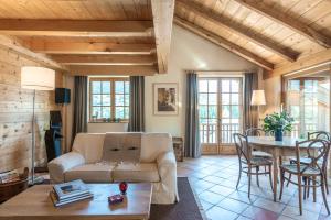 a living room with a couch and a table at Ferme Vauvray in Megève
