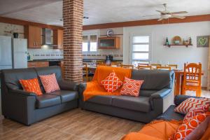 a living room with two couches and a kitchen at Paradise Ebro 2 in Deltebre