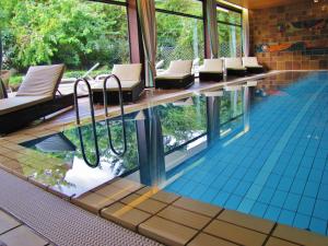 a pool with a bunch of chairs in a building at Hotel Kloster Hirsau in Calw