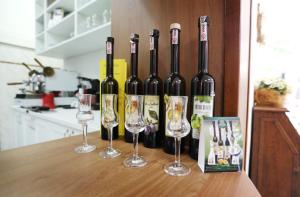 a group of wine bottles and wine glasses on a table at Penzión SENEC in Senec