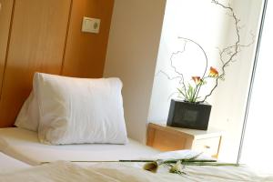 Łóżko lub łóżka w pokoju w obiekcie Hotel St. Virgil Salzburg