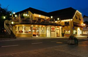 a building with lights on a street at night at Café Rainer in Sankt Johann in Tirol