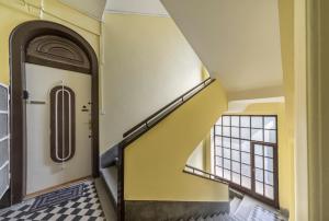 a hallway with a stairway leading up to a door at Miso Apartment in Budapest