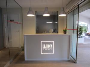 an office with a lobby with a sign on a counter at Apartamentos LLorca in Platja de l’Almadrava