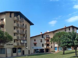 un gran edificio de apartamentos con árboles delante de él en Apartment Trinquart-1 by Interhome, en Seignosse