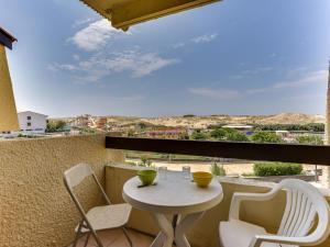 a white table and chairs on a balcony with a view at Apartment Trinquart-1 by Interhome in Seignosse