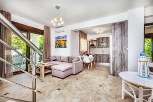 a living room with a couch and a table at Sunset Villas in Possidi