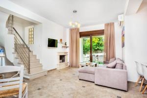 a living room with a couch and a fireplace at Sunset Villas in Possidi