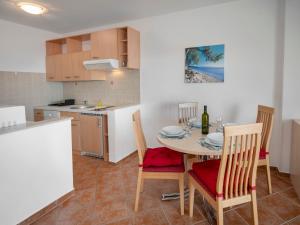 una cucina e una sala da pranzo con tavolo e sedie di Apartment Josipa-3 by Interhome a Klenovica