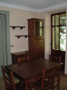 a dining room with a wooden table and chairs at Residenza Italia in Casteldelfino