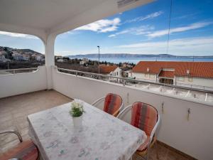 a balcony with a table and chairs and a view of the water at Apartment Josipa-2 by Interhome in Klenovica +24 photos