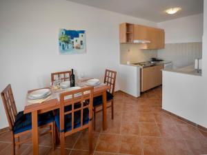 a kitchen and dining room with a table and chairs at Apartment Josipa-2 by Interhome in Klenovica